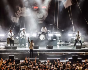 live concert lighting production with LED beams and audience crowd