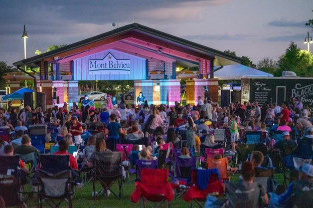 Taylor swift tribute artist singing in front of large crowd