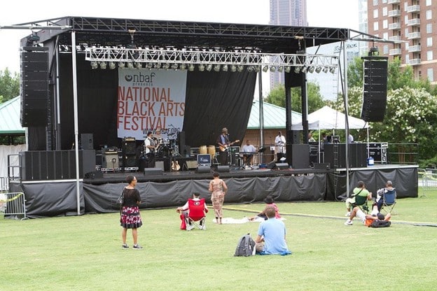 A full outdoor festival stage showing towers and roof structure