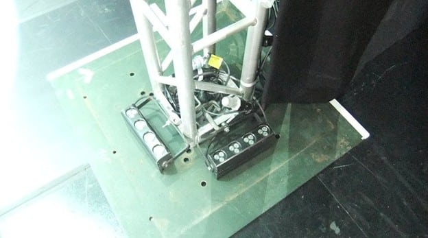 Truss tower base plate showing the connection point between the vertical tower and the ground support.