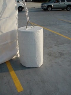 Water ballast barrel with rope attachment.