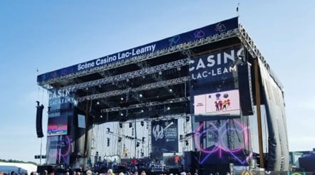 Outdoor stage truss superstructure with suspended speaker arrays, led walls, banners and lighting rigs