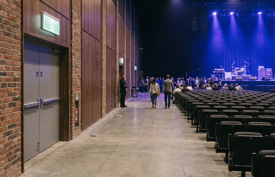 Empty concert venue with audience gathering.