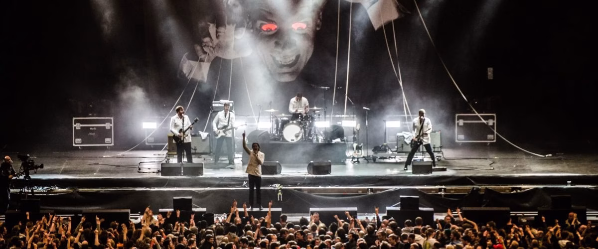 live concert lighting production with LED beams and audience crowd